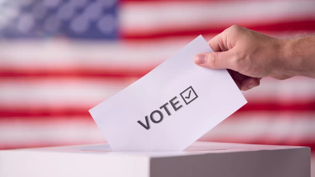 hand-voting-with-an-american-flag-background