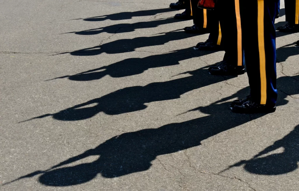 shadows-of-uniformed-figures-in-formation