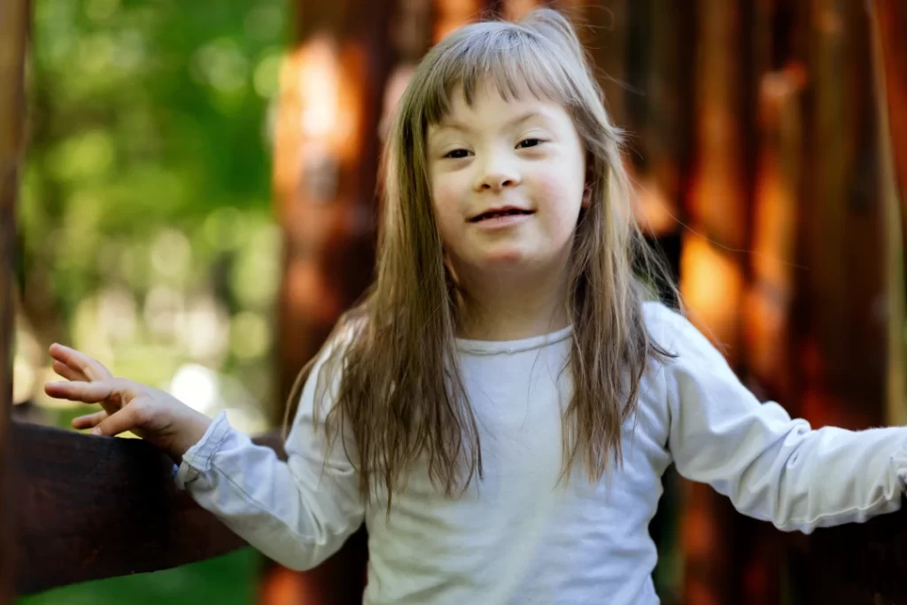 smiling-young-girl-poses-outdoors-among-trees
