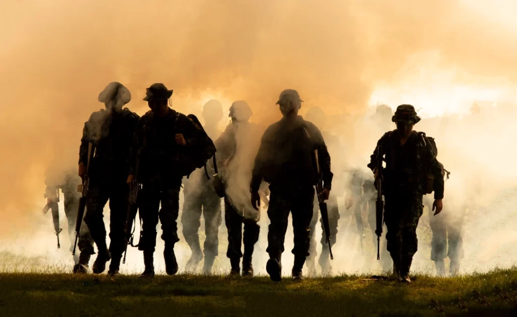 troops-walking-through-smoke-in-a-field