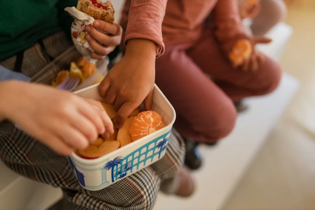 group-of-classmates-having-fruit-snack