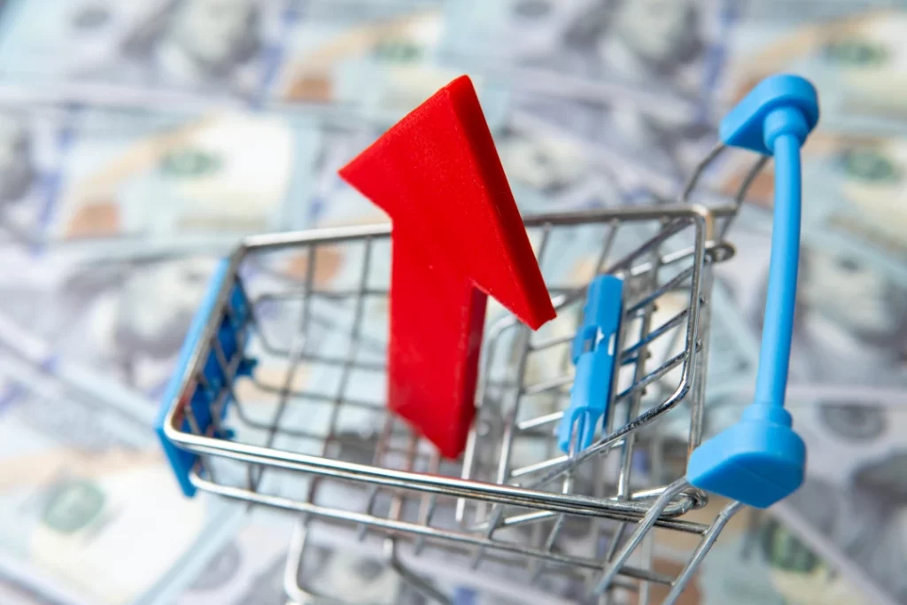 rising-market-arrow-and-shopping-cart-on-money