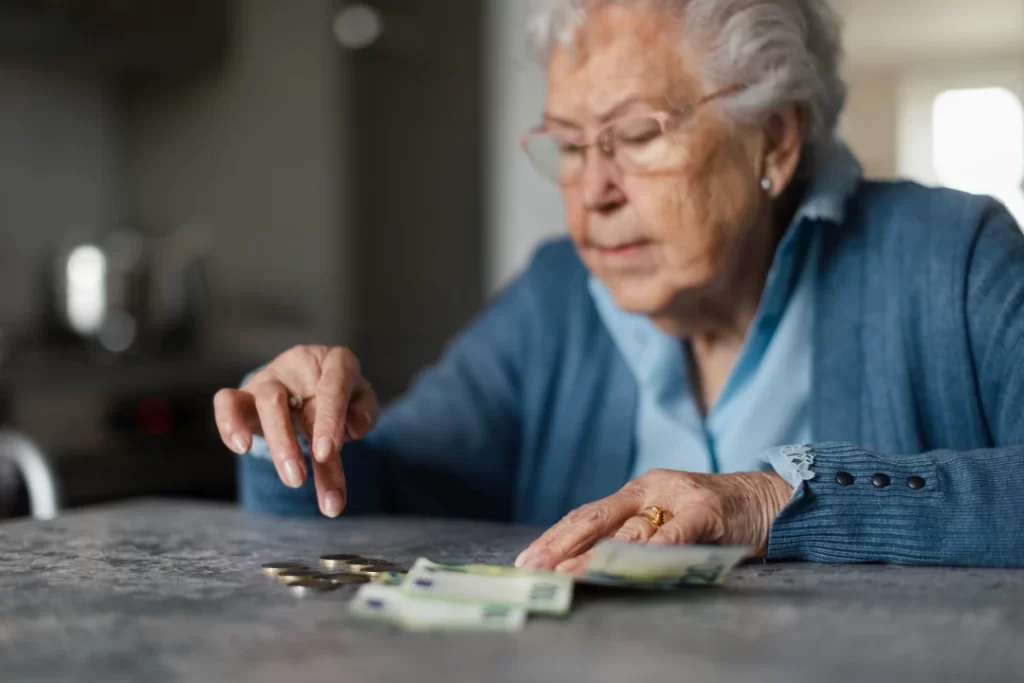 senior-woman-counting-money-at-her-table